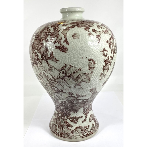 414 - A large Chinese inverted baluster vase with red wave decoration with dragons in relief between the w... 