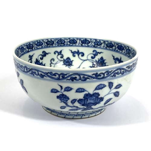 416 - A Chinese blue and white bowl decorated with flowers and fruits etc with six character mark to base,... 