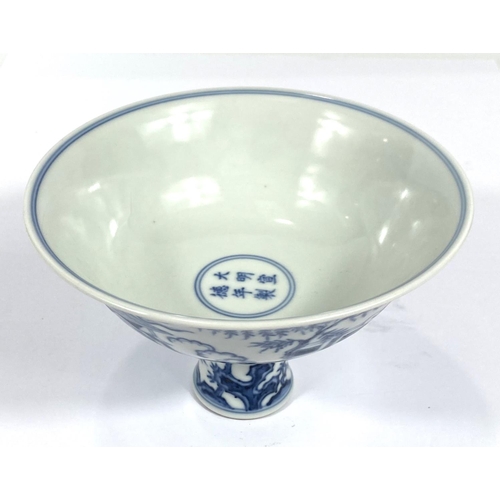 427 - A large Chinese blue and white stem cup with traditional decoration, domestic scene trees plants etc... 