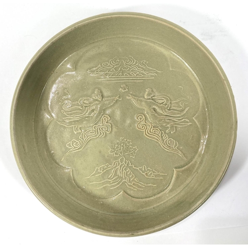 430 - Two Chinese green glazed dishes with relief decorated scenes to base of dishes, diameter 22cm and 20... 