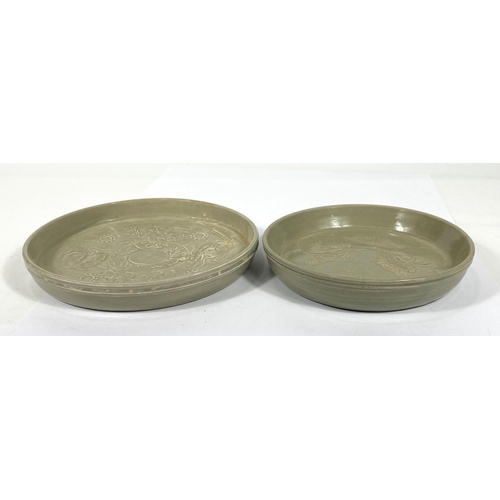 430 - Two Chinese green glazed dishes with relief decorated scenes to base of dishes, diameter 22cm and 20... 