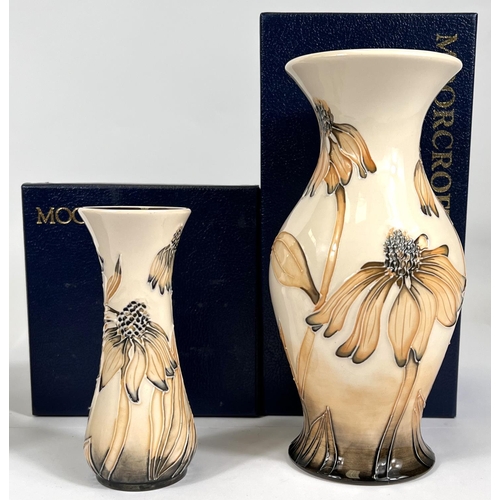 435 - An originally boxed Moorcroft vase of small stature with waisted middle Cornflower and a matching la... 