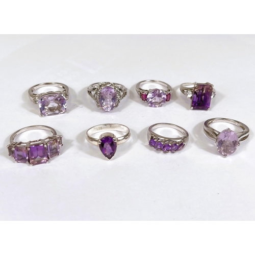 621 - Eight silver rings in a variety of designs, each set with 1 or more amethyst coloured stones, 39.4gm