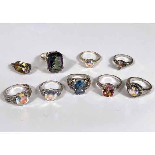 622 - Eight silver rings in a variety of designs, each set with an iridescent stone; a similar pendant, 43... 