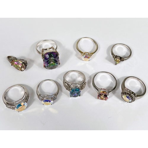 622 - Eight silver rings in a variety of designs, each set with an iridescent stone; a similar pendant, 43... 