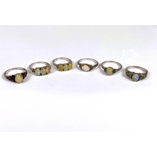 623 - Six silver rings all set with 1 or more opal/opal effect stones, 18.2gm