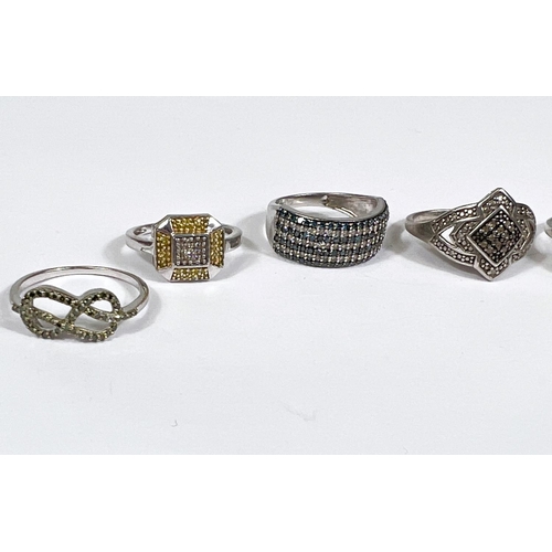 624 - Eight silver rings in a variety of designs, with assorted pavé set coloured stones, 23.1... 