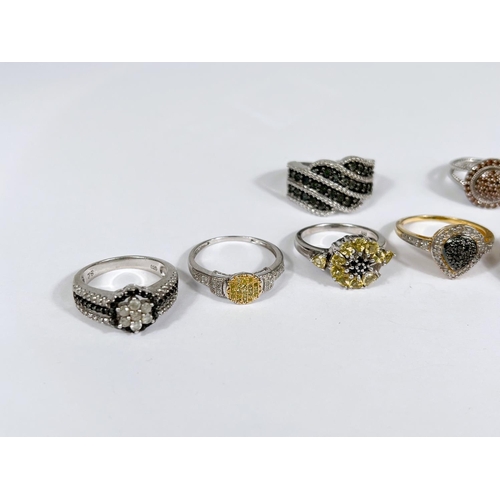 625 - Six silver rings in a variety of designs, with assorted pavé set coloured stones, 38gm