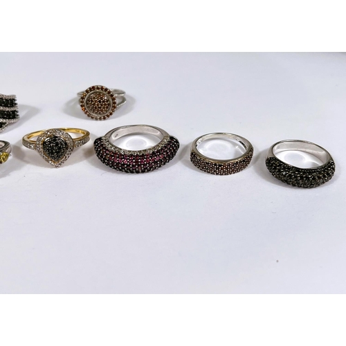 625 - Six silver rings in a variety of designs, with assorted pavé set coloured stones, 38gm