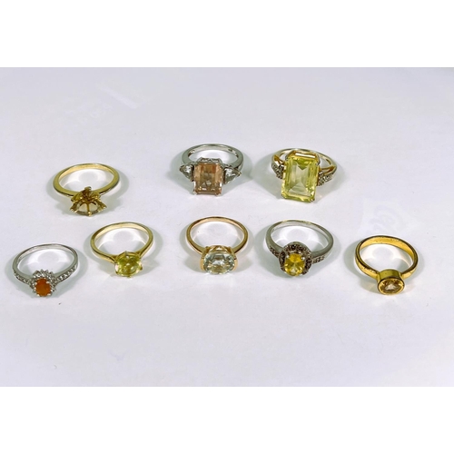 626 - Eight silver rings in a variety of settings, each with yellow toned stones, 28.1gm