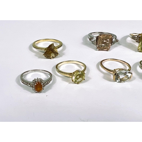 626 - Eight silver rings in a variety of settings, each with yellow toned stones, 28.1gm