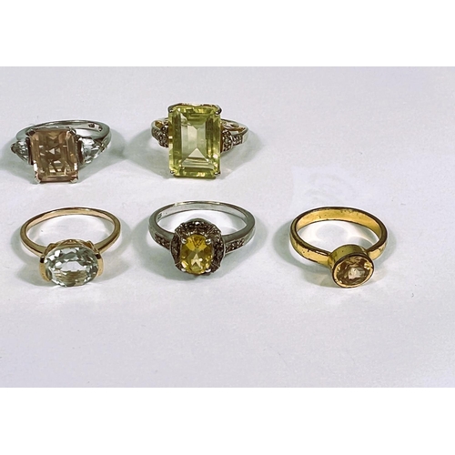 626 - Eight silver rings in a variety of settings, each with yellow toned stones, 28.1gm