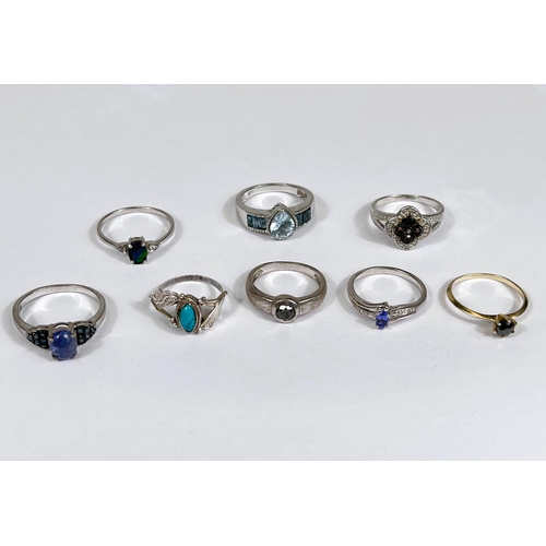 632 - Eight silver rings in a variety of designs, set blue tone stones, 21.5gm