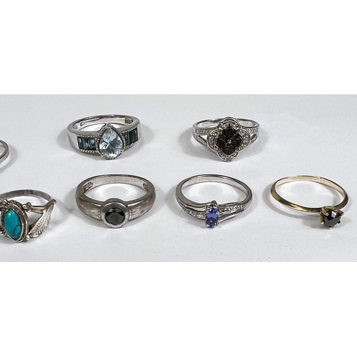 632 - Eight silver rings in a variety of designs, set blue tone stones, 21.5gm