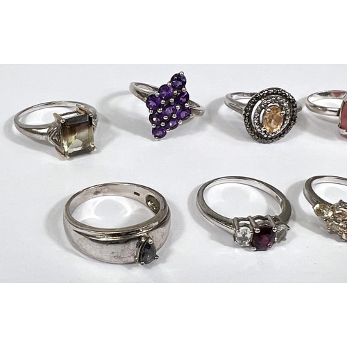 636 - Eight silver rings in a variety of designs, set assorted coloured stones, 27.2gm