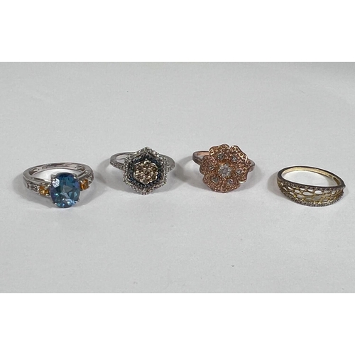 639 - A silver ring set large oval colour changing stone; a gold toned silver ring with small diamonds in ... 