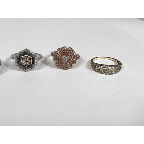 639 - A silver ring set large oval colour changing stone; a gold toned silver ring with small diamonds in ... 