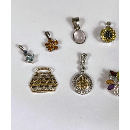 640 - Ten silver pendants set with a variety of coloured stones