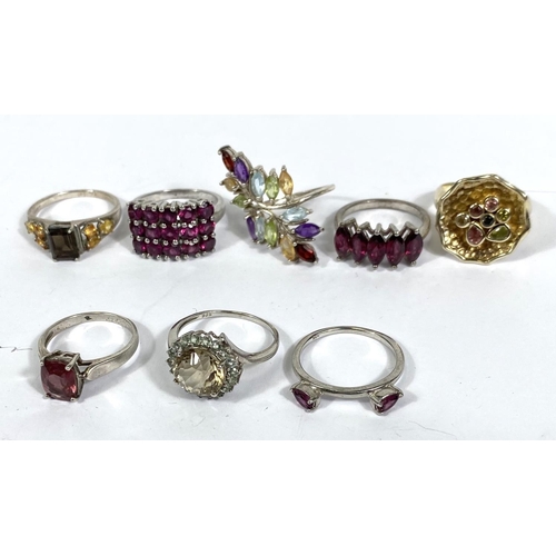 640A - Eight silver rings, stamped '925', variety of designs and set with a variety of coloured stones