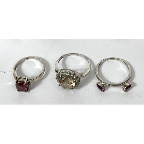 640A - Eight silver rings, stamped '925', variety of designs and set with a variety of coloured stones