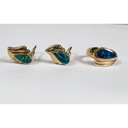 647 - A yellow metal dress ring with broad ribbed top, inset elongated dark blue opal type stone; a pair o... 