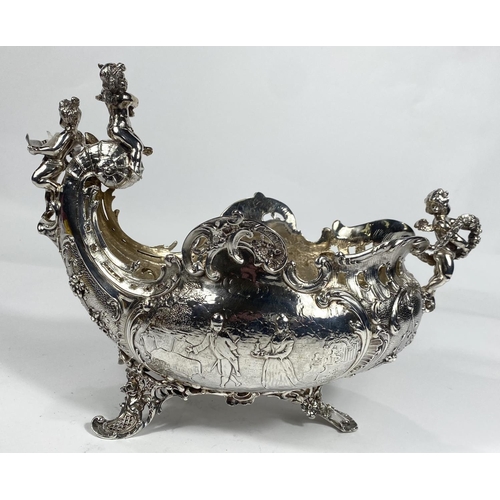 698 - A 19th century French rococo vase, boat shaped with cherub mounts to the prow and stern and extensiv... 