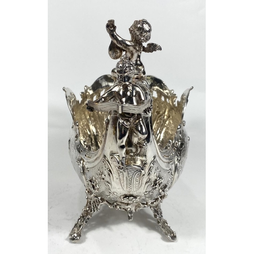 698 - A 19th century French rococo vase, boat shaped with cherub mounts to the prow and stern and extensiv... 