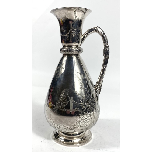 700 - A hallmarked silver wine jug of tapering baluster form and cane effect handle, chased with herons an... 