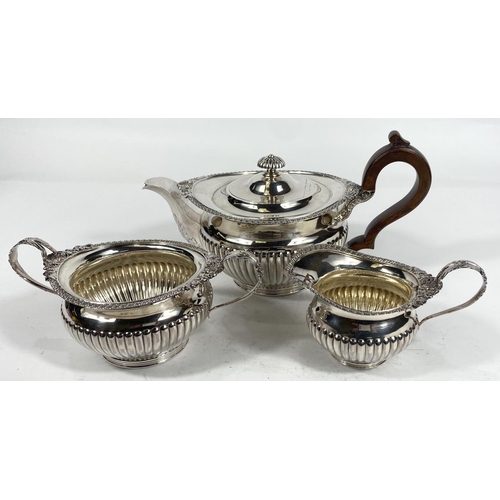 701 - A 3 piece hallmarked silver tea set in the Georgian style with gadrooned and floral borders and ribb... 
