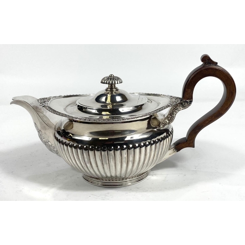 701 - A 3 piece hallmarked silver tea set in the Georgian style with gadrooned and floral borders and ribb... 