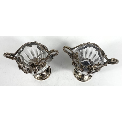 709 - A Continental pair of cut glass vases, ovoid ribbed form with extensive cast white metal mounts on t... 