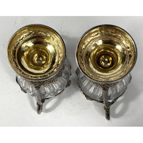 709 - A Continental pair of cut glass vases, ovoid ribbed form with extensive cast white metal mounts on t... 