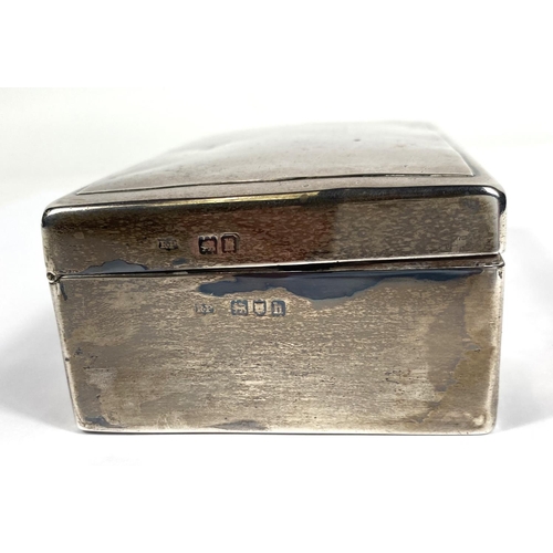 711 - A hallmarked silver rectangular cigarette box with hinged lid and weighted base, London 1903 (some d... 