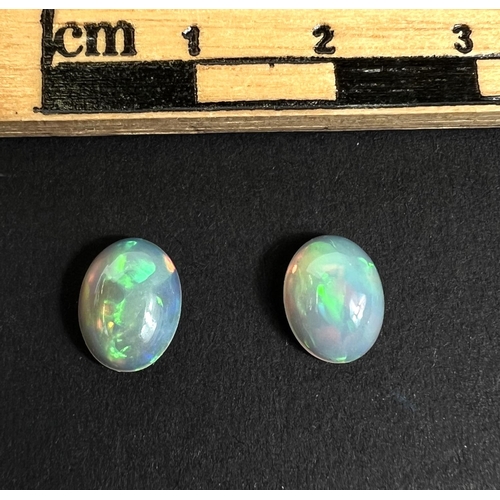 719 - Two oval cabochon opals, 2.15 carat