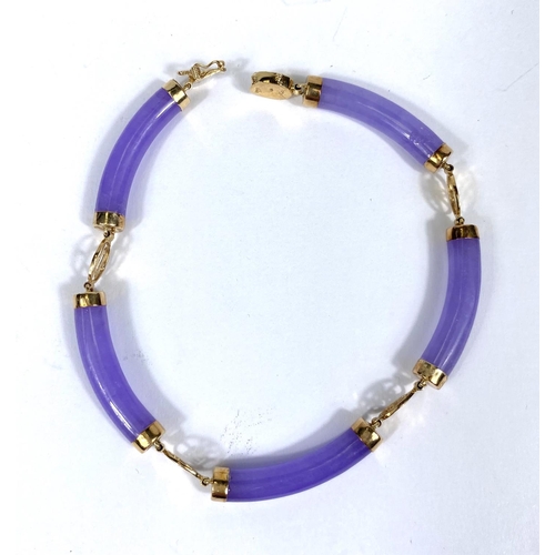 725 - A modern bracelet formed from rounded tubular amethyst coloured links, with carat hallmarked gold cl... 