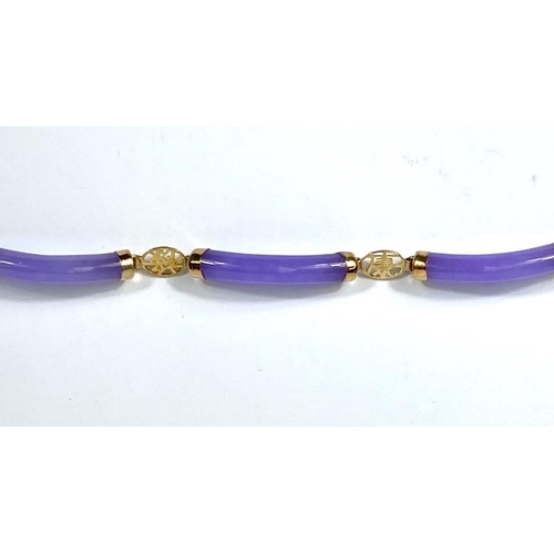 725 - A modern bracelet formed from rounded tubular amethyst coloured links, with carat hallmarked gold cl... 