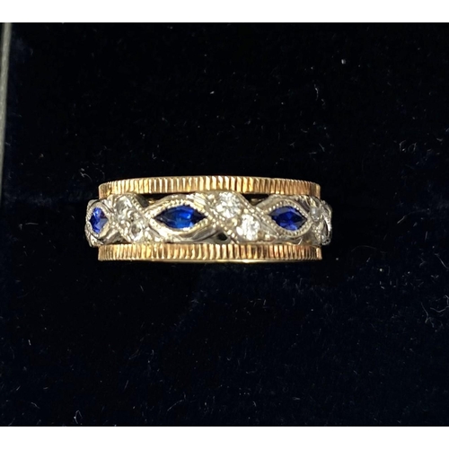 732 - A two tone yellow and white metal dress ring set with blue and white sapphires, 3.6gms, size K