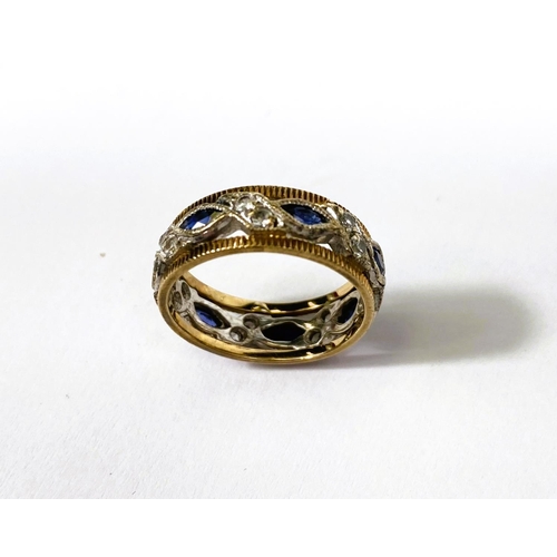 732 - A two tone yellow and white metal dress ring set with blue and white sapphires, 3.6gms, size K