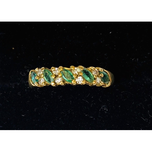 733 - A gold dress ring, hallmarks worn, set with 5 emerald coloured stones and smaller diamonds around, s... 