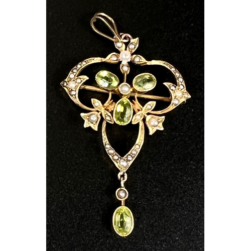 748 - An Edwardian peridot and seed pearl leaf shaped pendant/brooch, stamped 9ct, 4.1gm