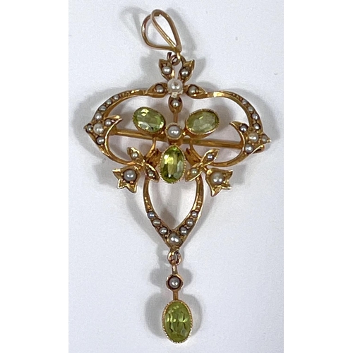 748 - An Edwardian peridot and seed pearl leaf shaped pendant/brooch, stamped 9ct, 4.1gm