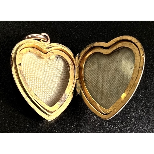 752 - A monogrammed heart pendant locket set with a sapphire, 3.4gm (tests as circa 9ct)