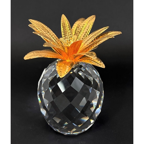 505 - A Swarovski crystal pineapple with gilt leaves, ht. 10cm; a Swarovski crystal Solaris cand... 