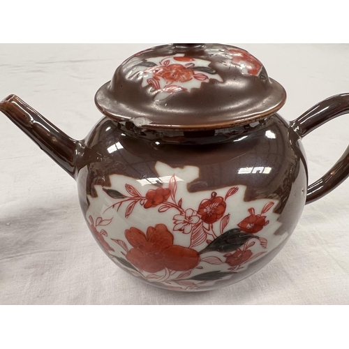 363 - An 18th century Chinese Batavia teapot with burnt orange floral decoration and brown glaze (with chi... 