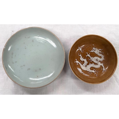 364 - A 19th century oriental pale green glazed dish and a Chinese round glazed dish with relief dragon to... 