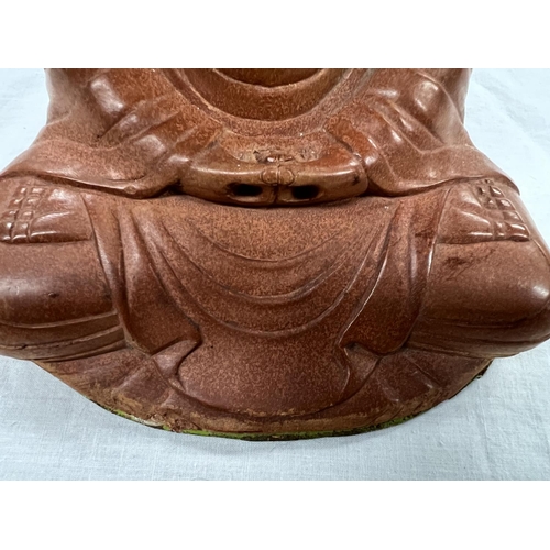 365 - A Japanese stoneware depiction of Buddha seated in lotus position height 18cm