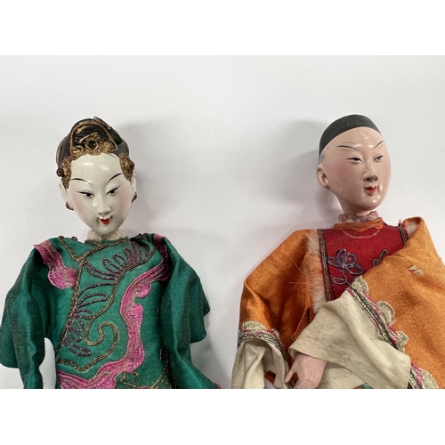 370 - 2 Chinese opera dolls in traditional clothes, painted faces with associated box height 25.5cm