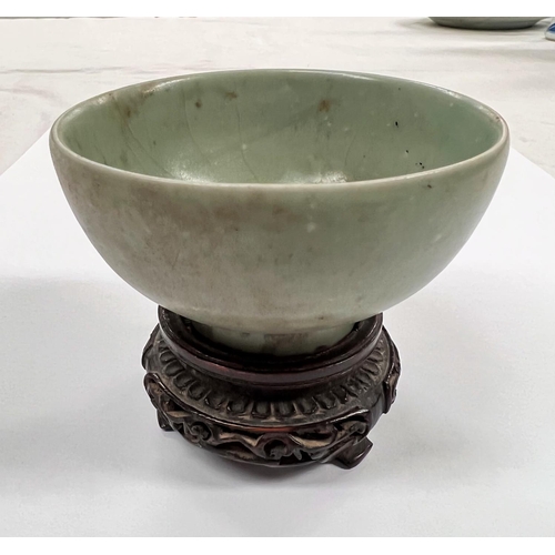 375 - A Chinese celadon glazed bowl with foot on associated hardwood stand diameter 9.5cm