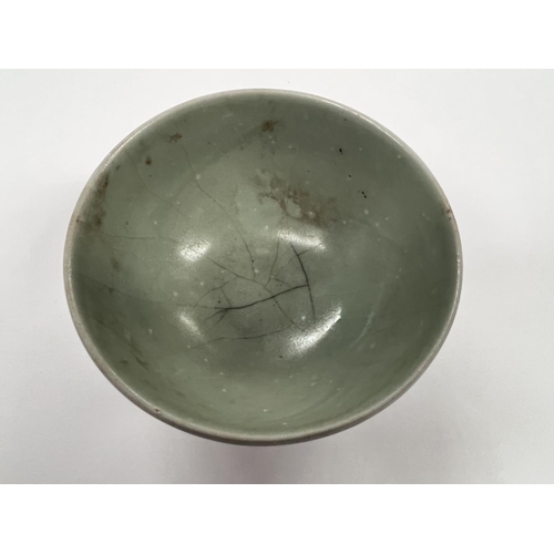 375 - A Chinese celadon glazed bowl with foot on associated hardwood stand diameter 9.5cm