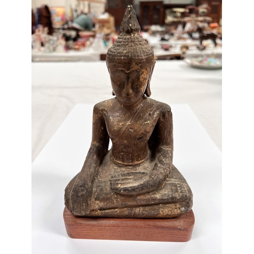 376 - A South East Asian carved wooden seated Buddha decorated in gilt with wooden base height 20cm 